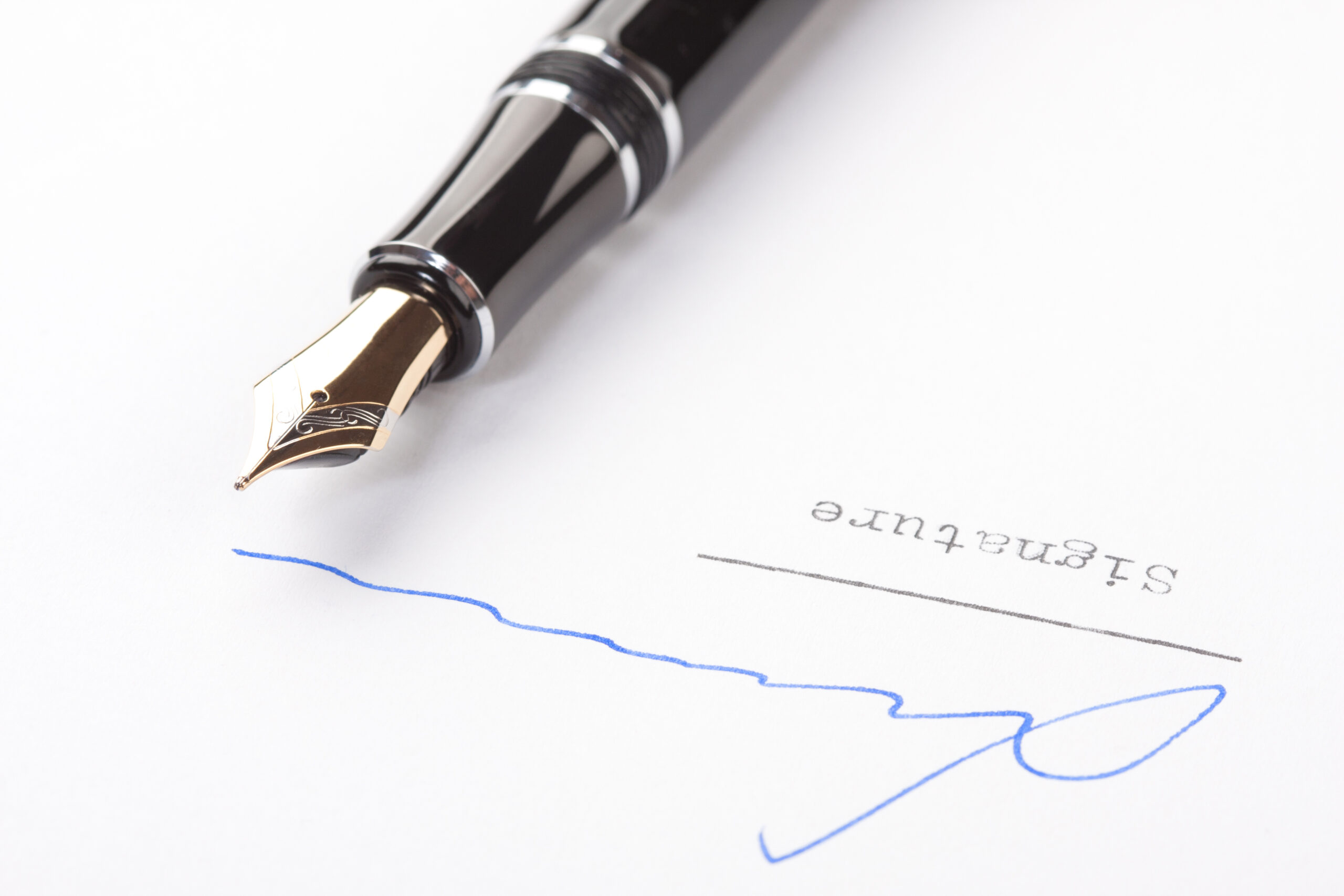 Signature on white paper with old fountain pen